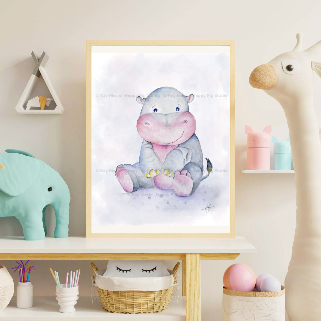 Harriet the Hippo fine-art print displayed in a pastel children’s room. Framed presentation shown for display inspiration. Print sold unframed. © Kay Mesia · Happy Pig Studio watermark applied at 12% opacity for online image protection.